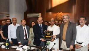 "KATI President Johar Qandhari presenting a shield to Minister Saeed Ghani, with other dignitaries in attendance."