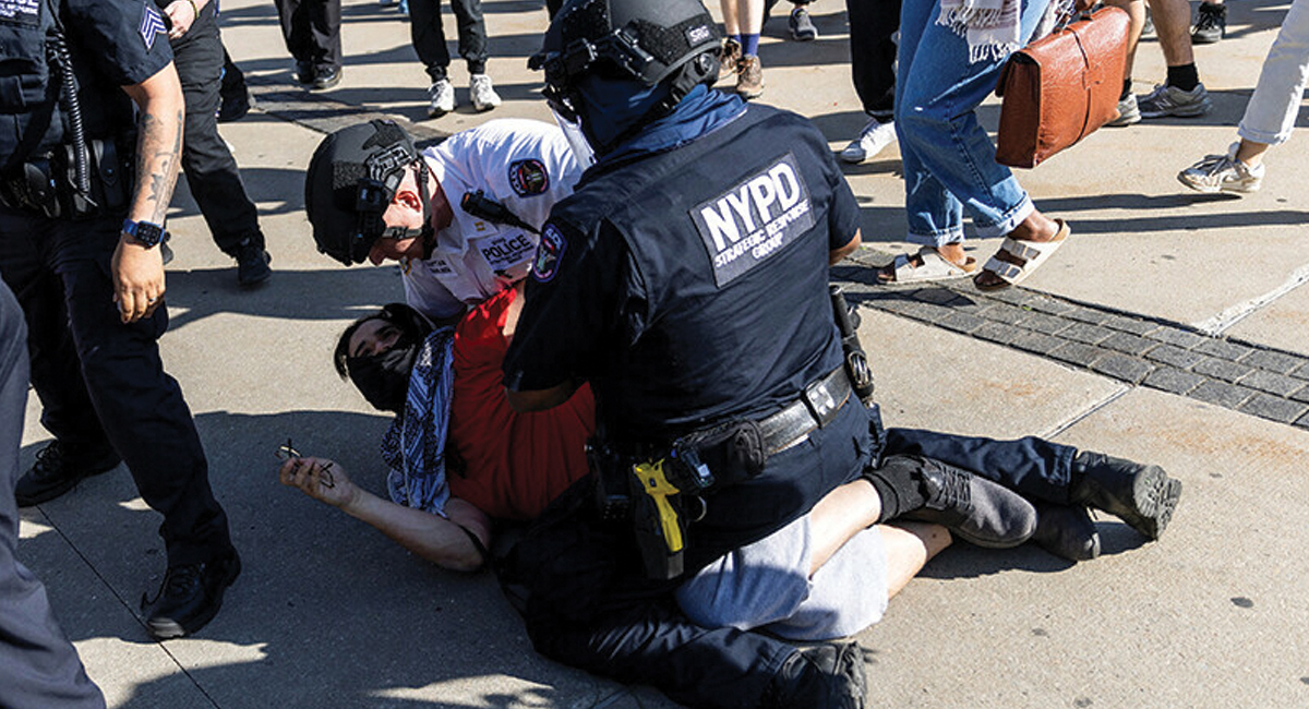 A Pro-Palestinian protestor is tackled and detained by New York Police Officers in front of the Brooklyn Museum during a protest in New York City on May 31.