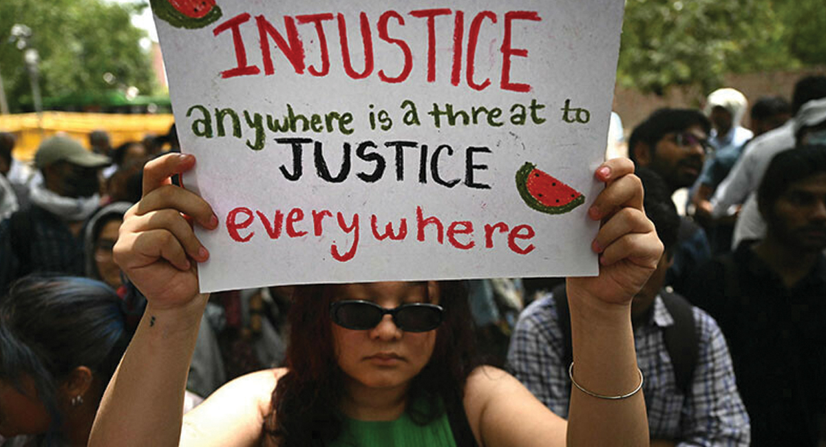 An activist holds a placard during a demonstration to express solidarity with Palestinians in New Delhi on June 1