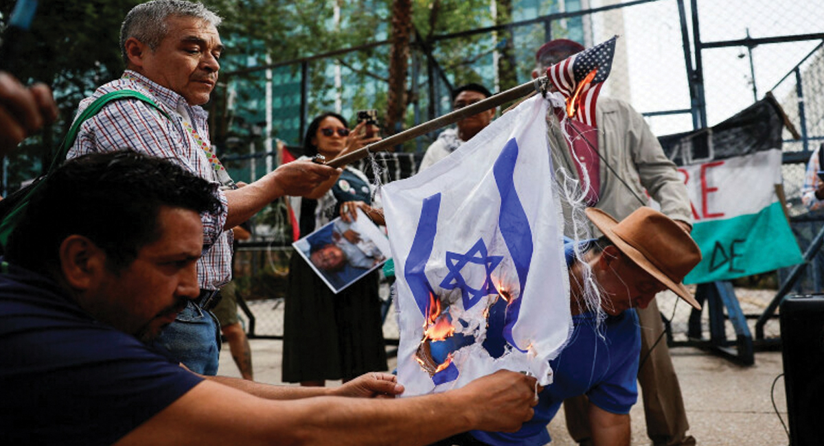 Demonstrators set fire to the flags of Israel and the US during a protest outside the US Embassy in Mexico on June 1, 2024, in support of Palestinians in Gaza.