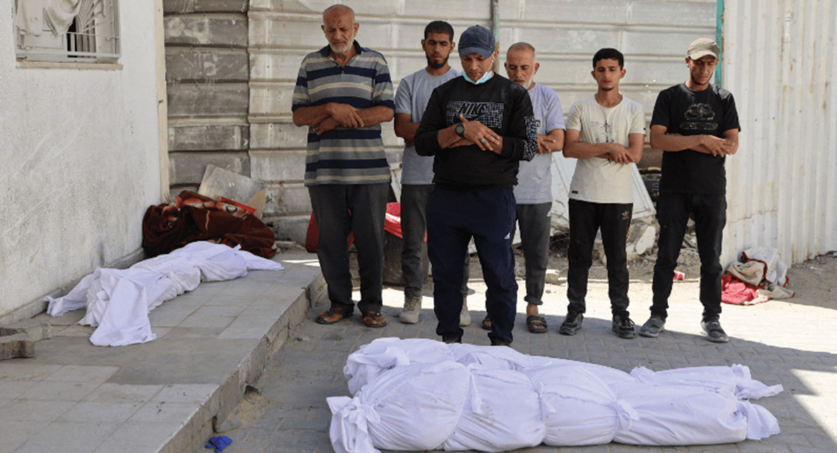 Palestinians pray over the bodies of Gazans killed in an Israeli strike in the Jabalia refugee camp in northern Gaza on June 1, 2024.